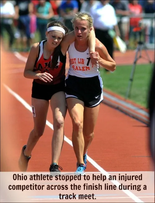 Athlete helping out injured athlete