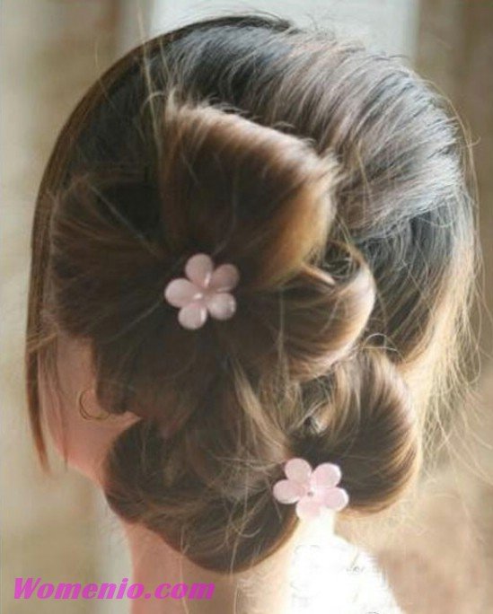 Finished double ponytail updo decorated with flowers