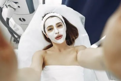 Woman with toothpaste facial mask on her face