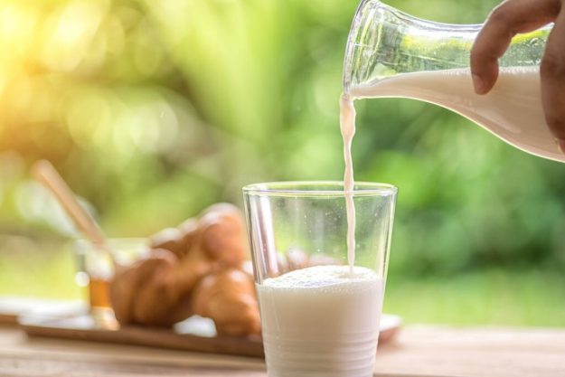 Pouring milk in a glass for a smoothie