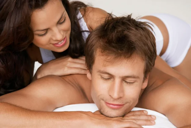Woman massages man with diy massage oil