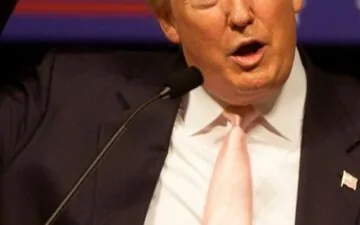 Donald Trump pointing at his head