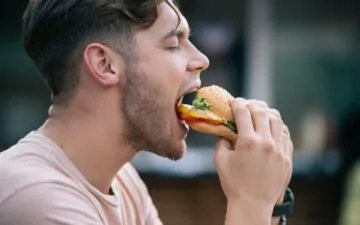 man eating a burger