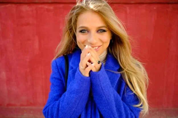 Rich blonde woman in blue coat