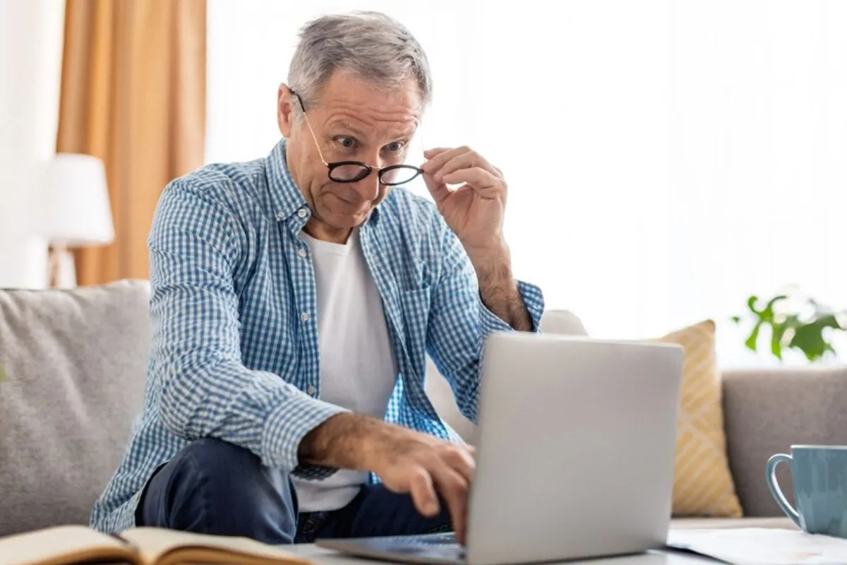 boomer looking at laptop